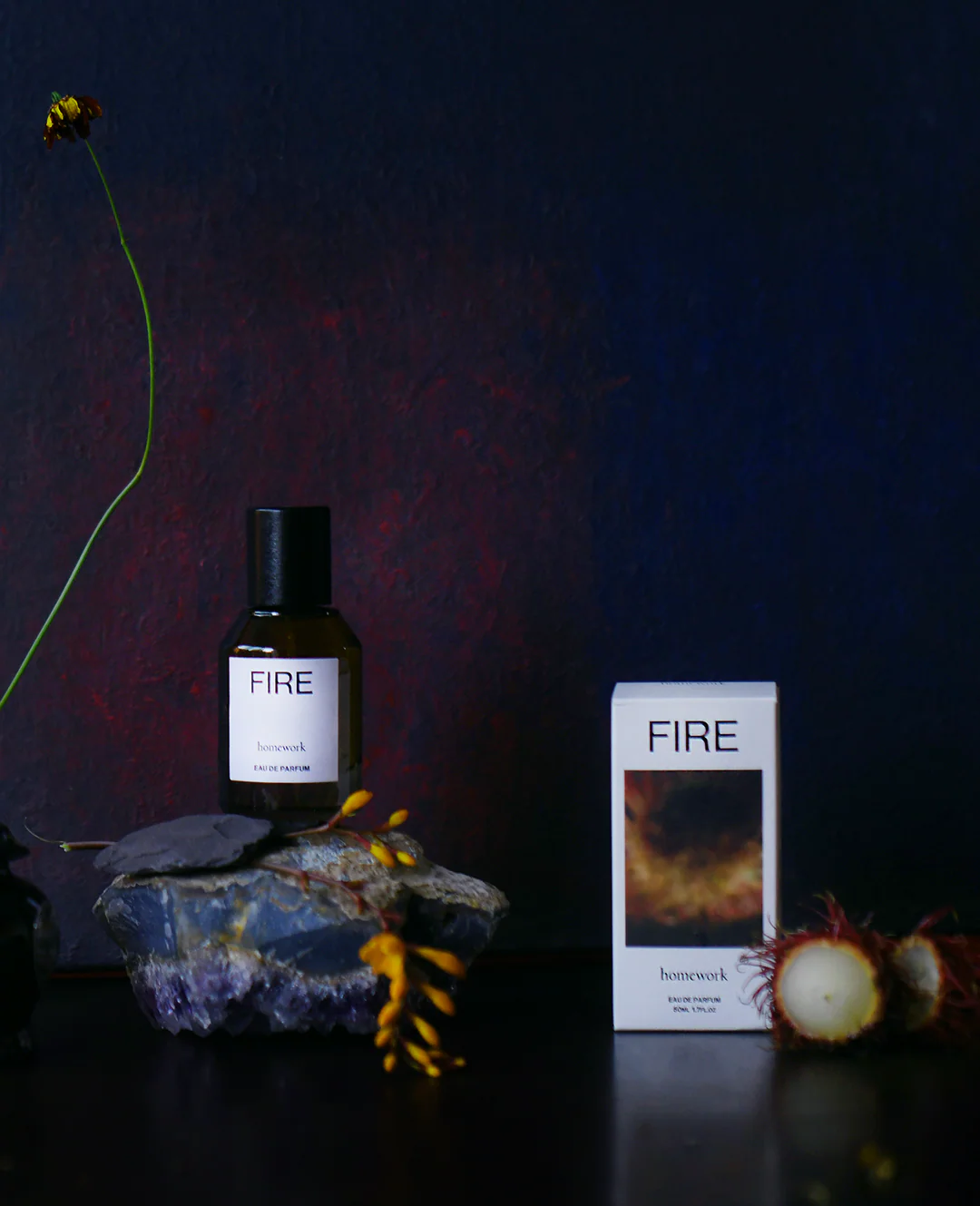 FIRE product bottle and packaging on a dark background with decorative elements.