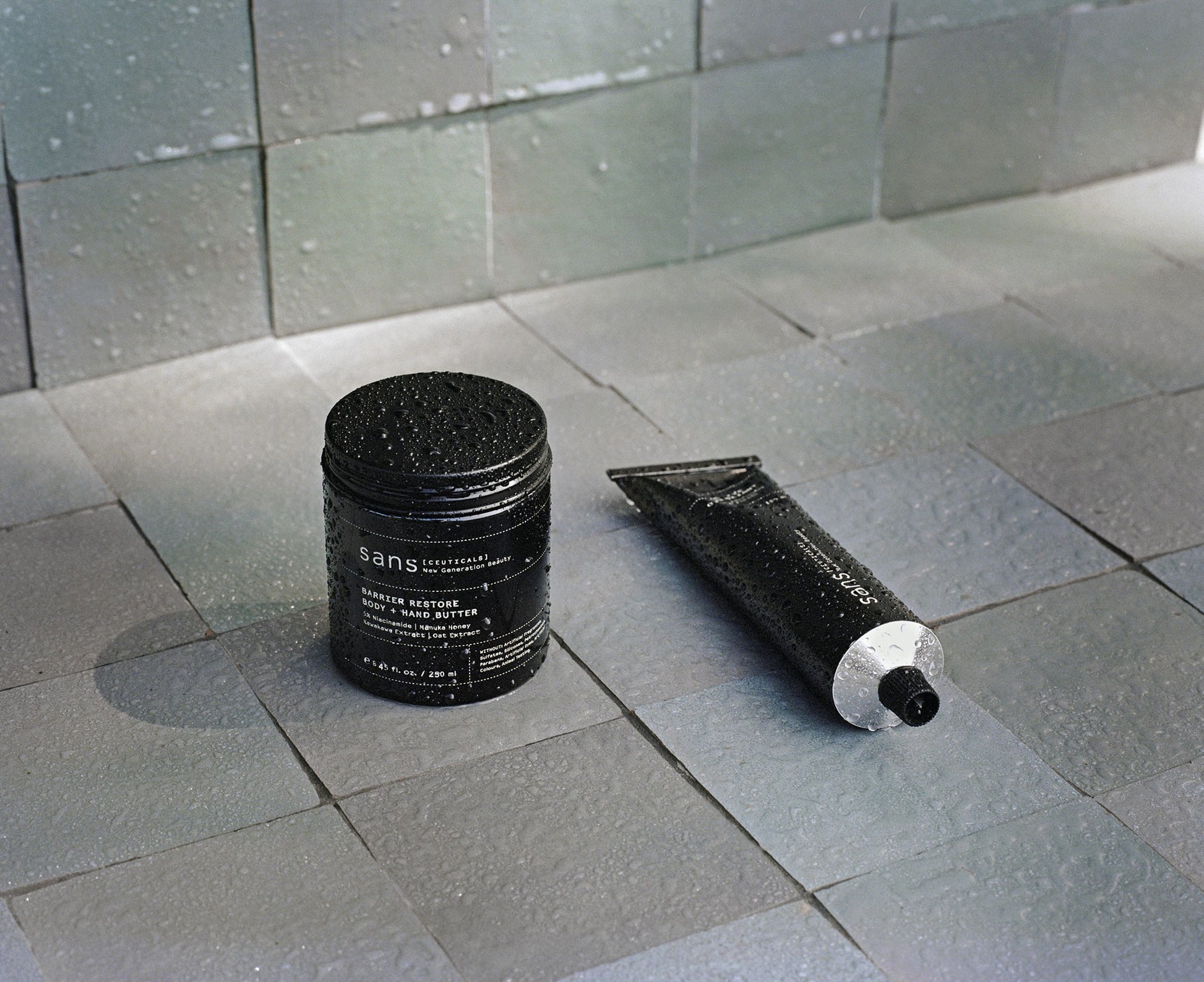 A jar and a tube on a tiled floor