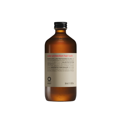 Brown bottle of color protection hair balm on a white background