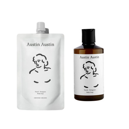 A bottle of Austin Austin Body soap with a refill pouch of the same soap next to it