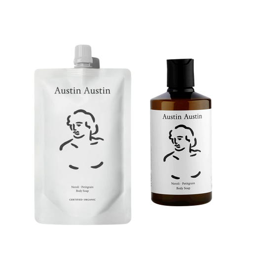 A bottle of Austin Austin Body soap with a refill pouch of the same soap next to it