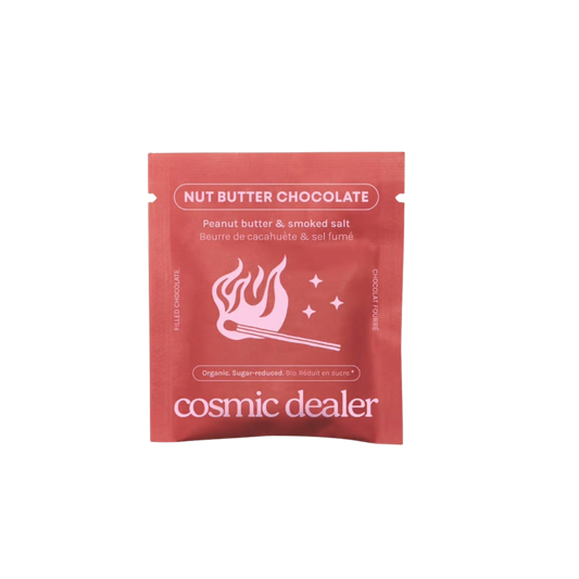 A single pink resealable pouch of Cosmic Dealer Nut Butter Chocolate, featuring a pink flaming match graphic and white text, centered on a plain white background.