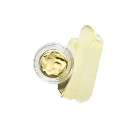 Gold-colored cream in a small open jar with a cotton swab on a white background