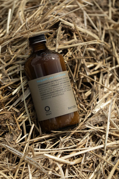 Brown bottle with label on a bed of straw