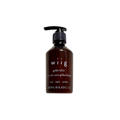 A 250ml pump bottle of wiig Goldie O/03 hair tone repair conditioner, designed for rich, warm golden blonde hair. The bottle is a dark amber brown with a black pump dispenser and white text on the front, set against a plain white background.