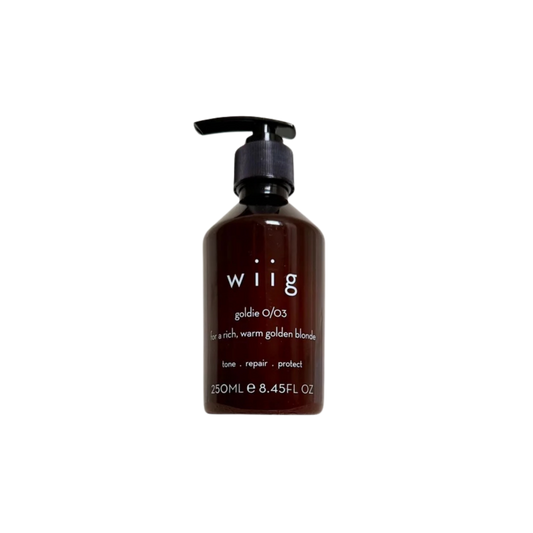 A 250ml pump bottle of wiig Goldie O/03 hair tone repair conditioner, designed for rich, warm golden blonde hair. The bottle is a dark amber brown with a black pump dispenser and white text on the front, set against a plain white background.
