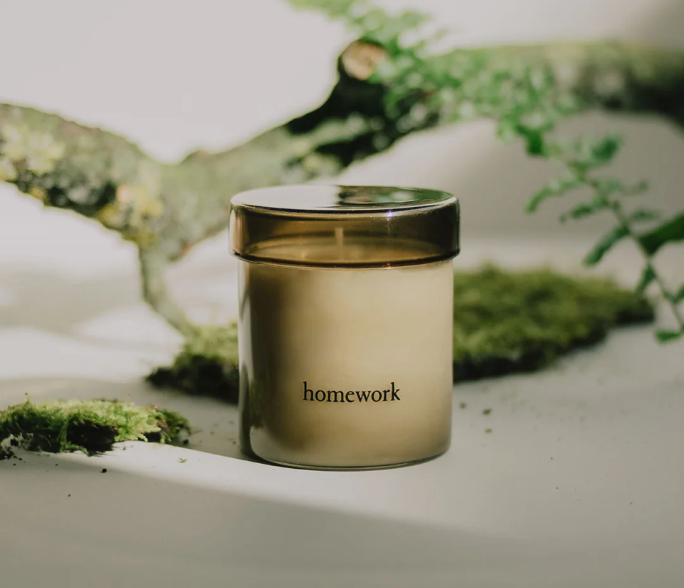 Jar labeled 'homework' on a natural background with greenery