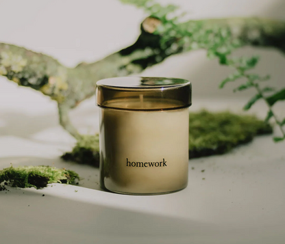 Jar labeled 'homework' on a natural background with greenery
