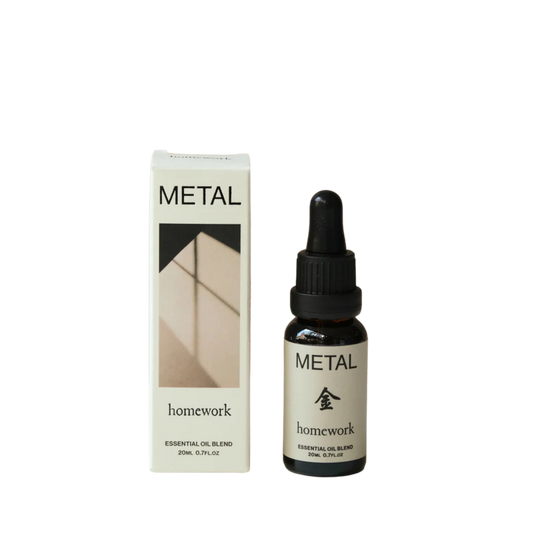 Bottle and box of 'Metal' homework essential oil blend on a white background
