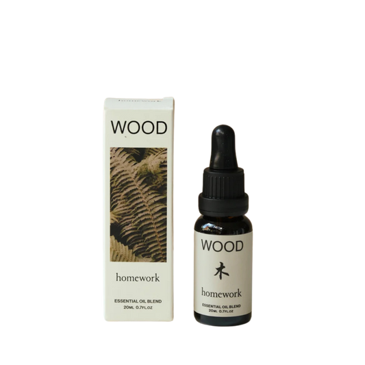 Essential oil bottle and packaging with 'WOOD' branding on a white background