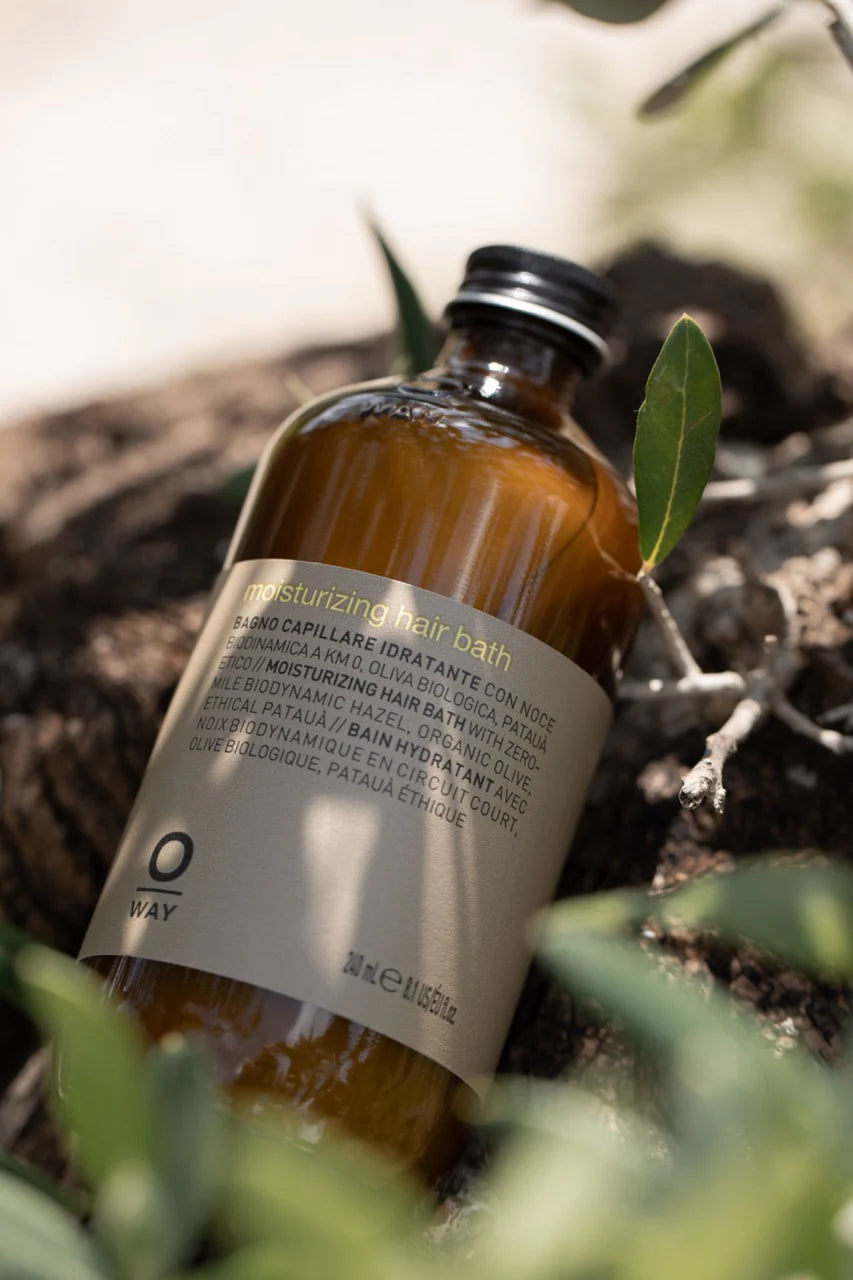 Bottle of hair bath with a label on a natural background