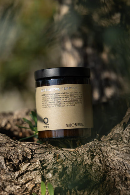 Jar of hair mask on a tree branch with a blurred natural background