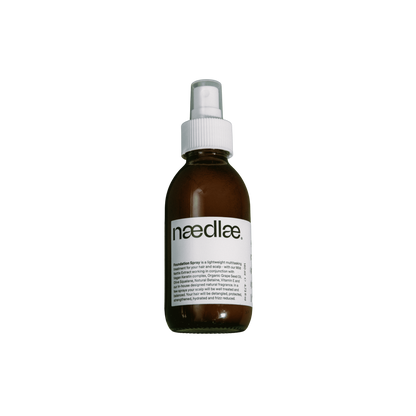 Brown spray bottle with white label on a white background