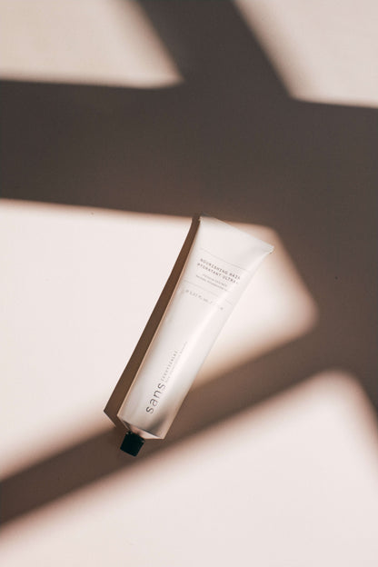 White tube of product on a neutral background