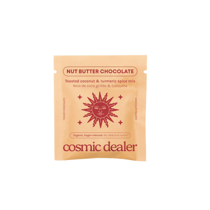A single packet of Cosmic Dealer Nut Butter Chocolate coconut and tumeric spice mix, featuring a peach-coloured pouch with a red sun graphic and text, centered on a plain white background.