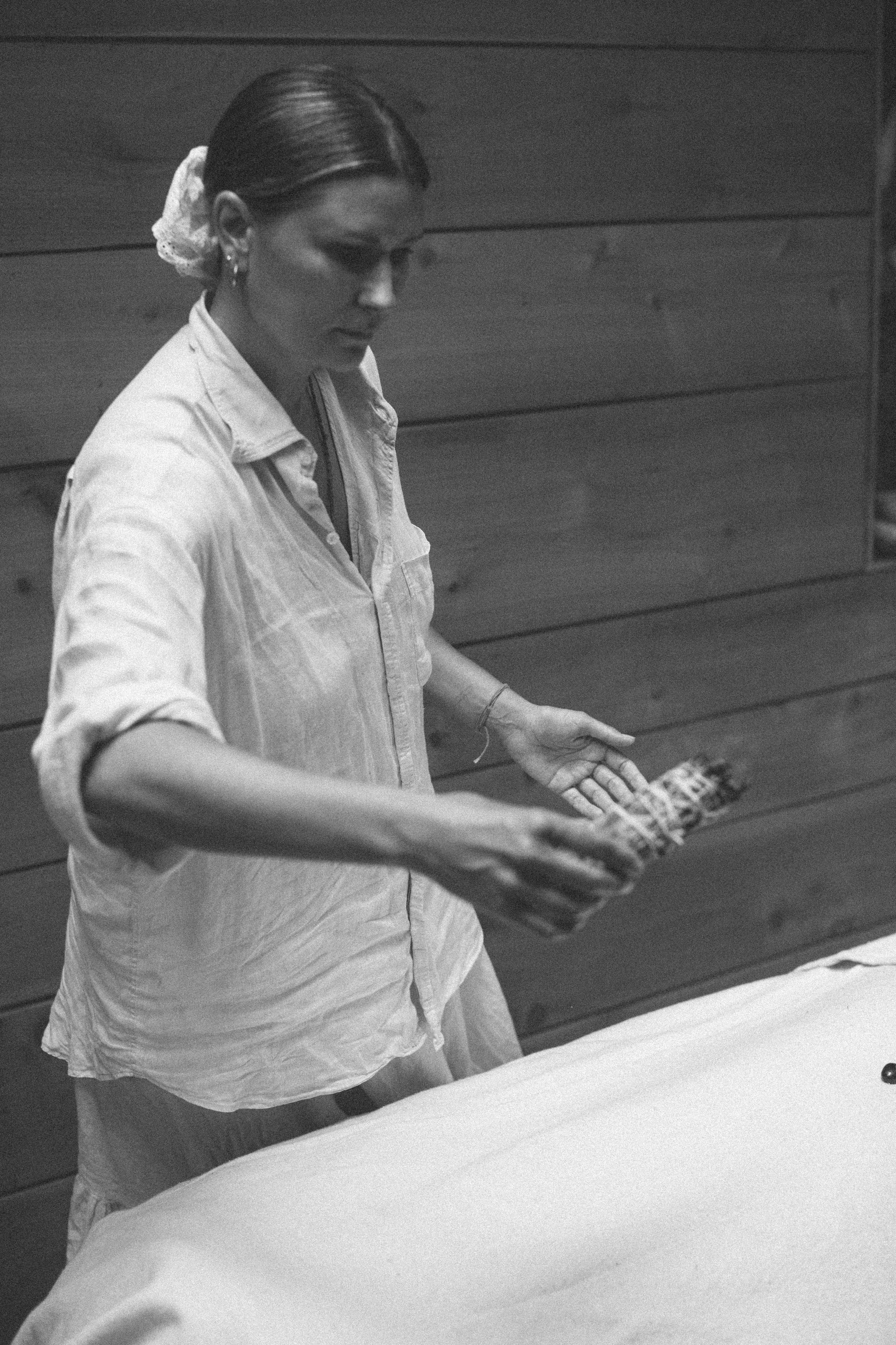 Olivia Crighton using a Sage-energy-clearing-healing smudge in an energy session at Glasshouse Salon East London