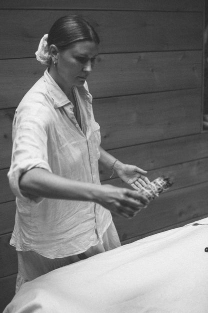 Olivia Crighton using a Sage-energy-clearing-healing smudge in an energy session at Glasshouse Salon East London