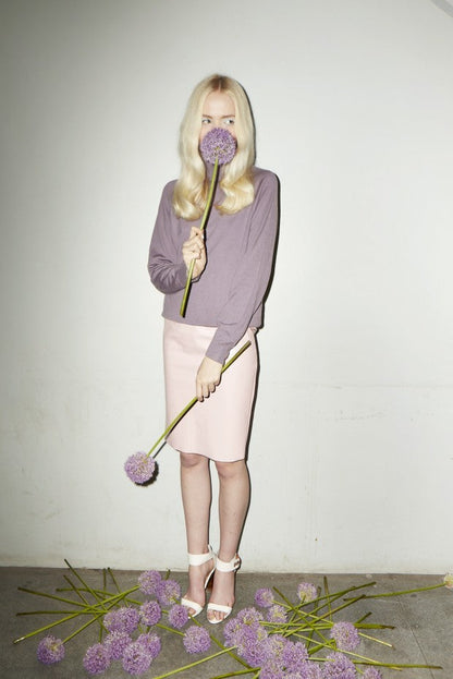 Blonde model with purple botanicals