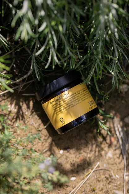 Jar of product with a gold label on a natural background