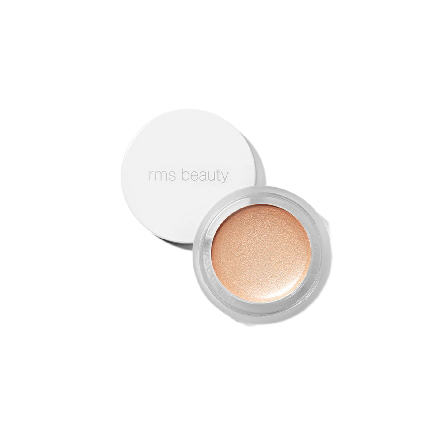 RMS Beauty Magic Luminizer in clear glass jar against plain white background showing warm champagne cream highlighter texture