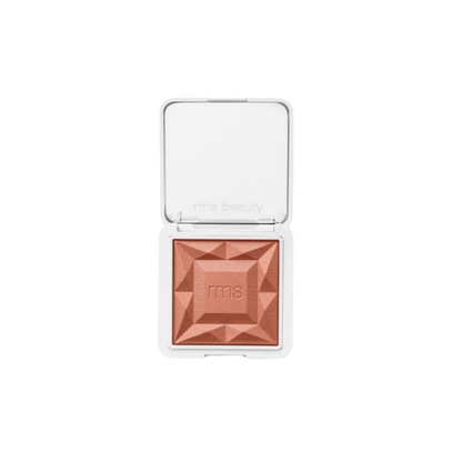 RMS Beauty diamond-shaped pressed powder blush in a warm peachy copper shade, shown in an open white compact with a mirror on a solid white background.
