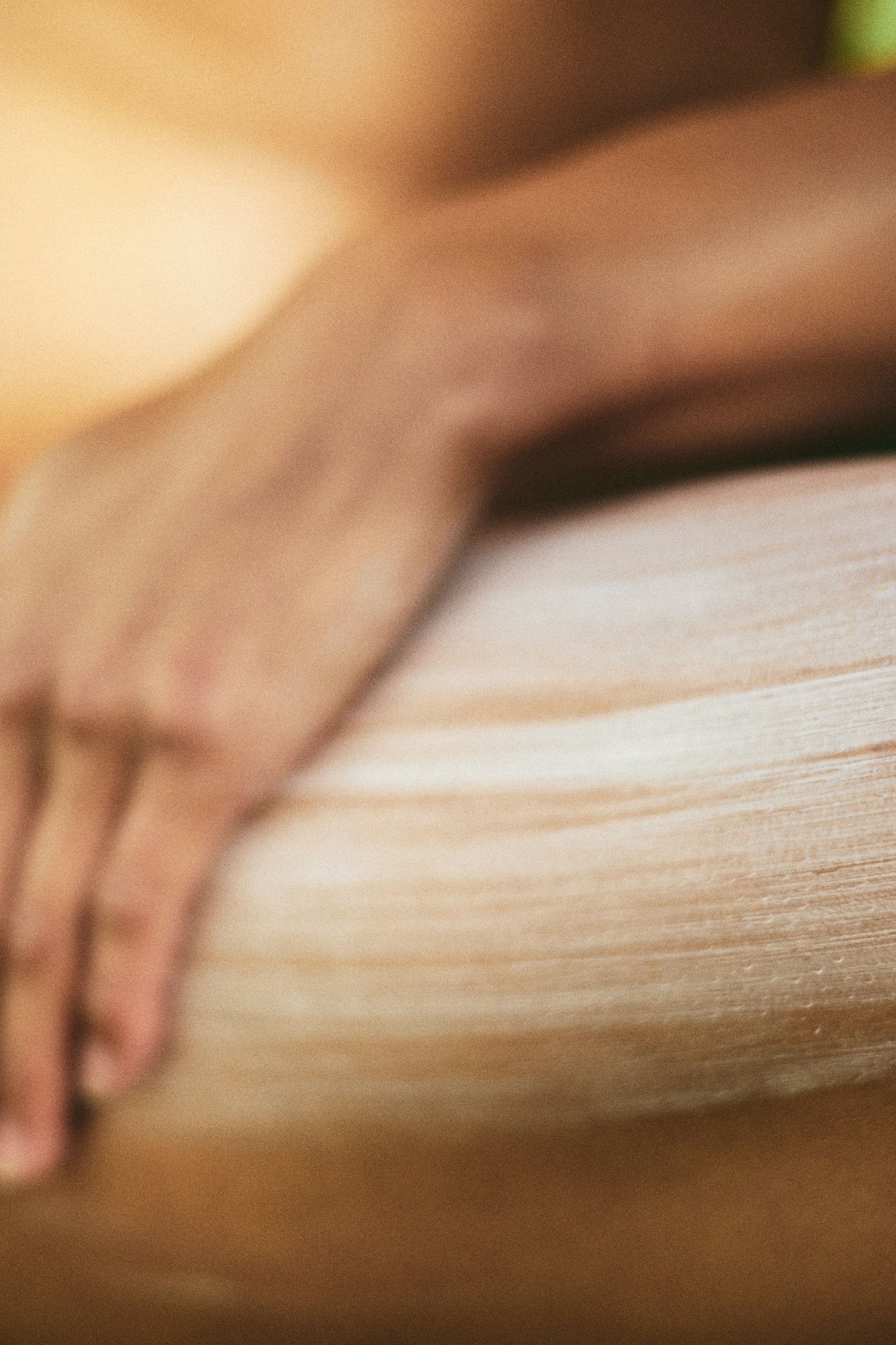 Close-up of a hand rubbing in cream to skin on leg