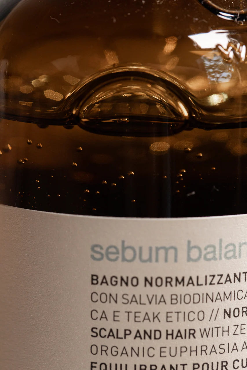 Close-up of a bottle label with 'sebum balance' text on a brown background