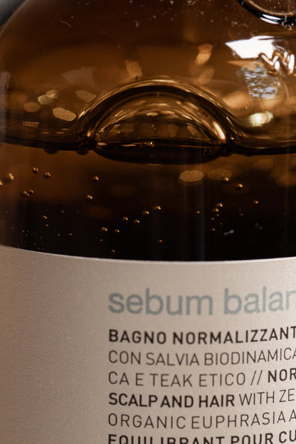Close-up of a bottle label with 'sebum balance' text on a brown background