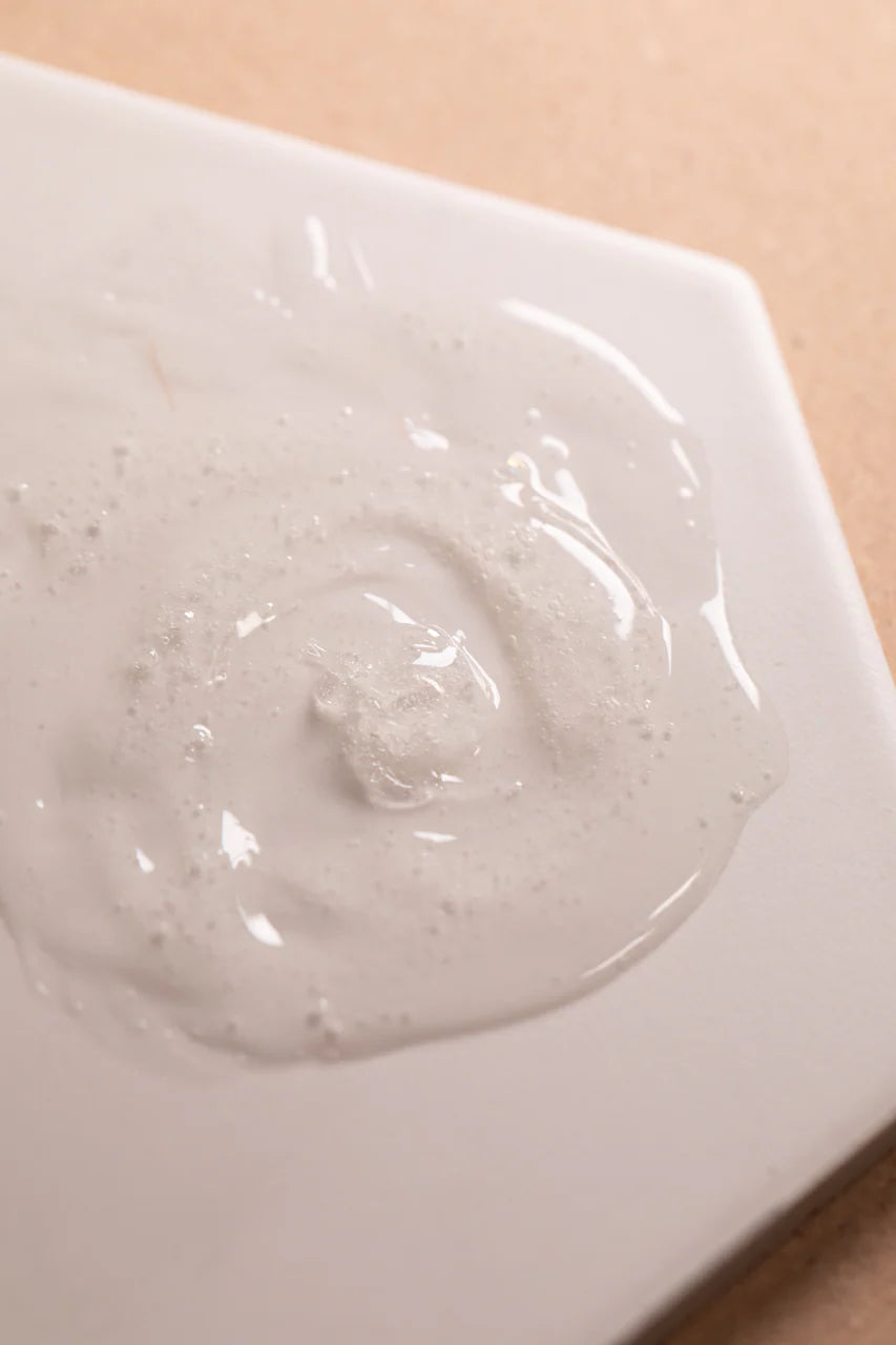 Close-up of a white cream or gel on a beige background