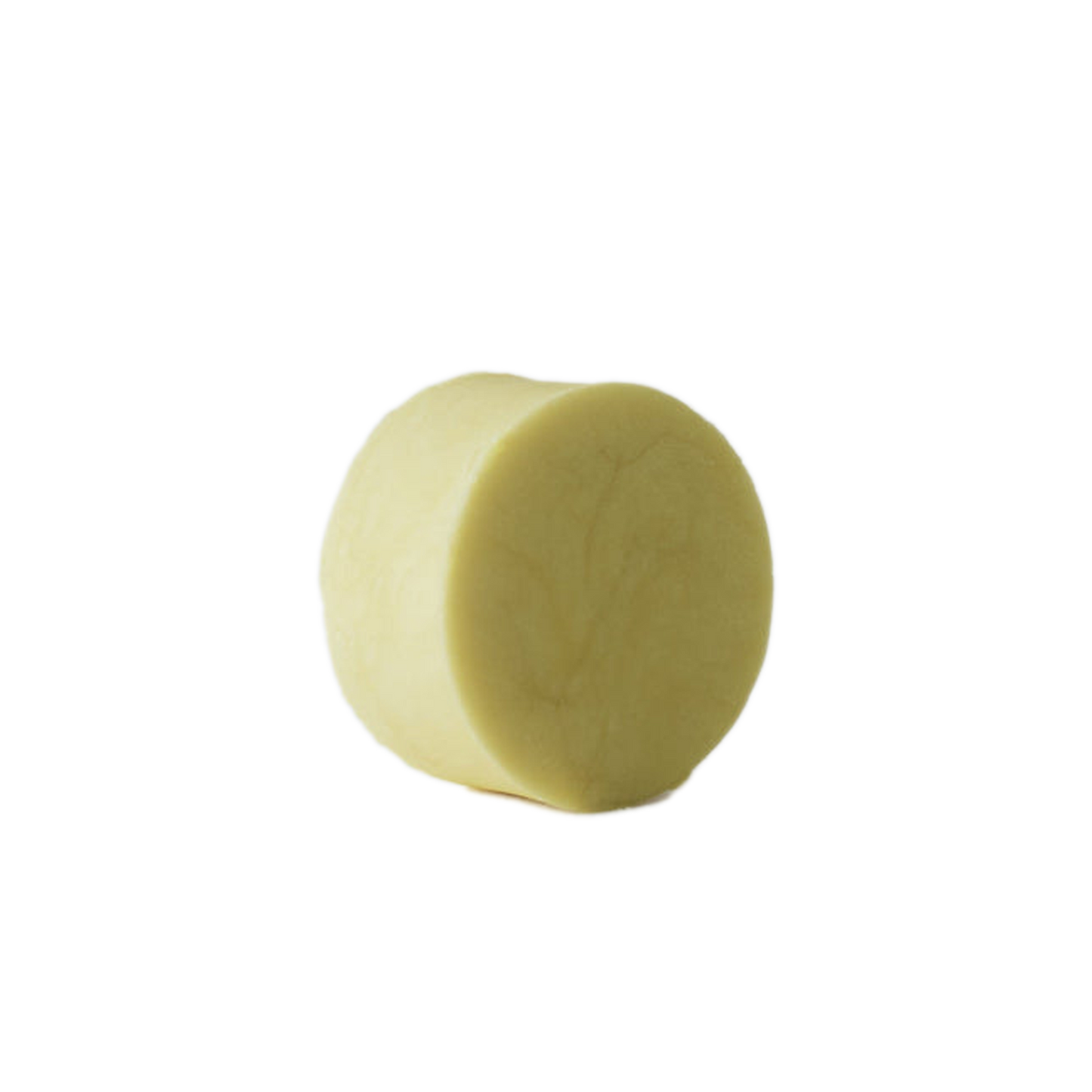 A cream coloured shampoo bar on a white baground