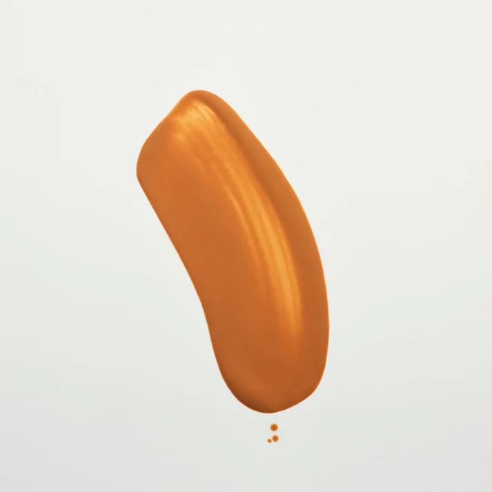 Orange foundation swatch on a white background