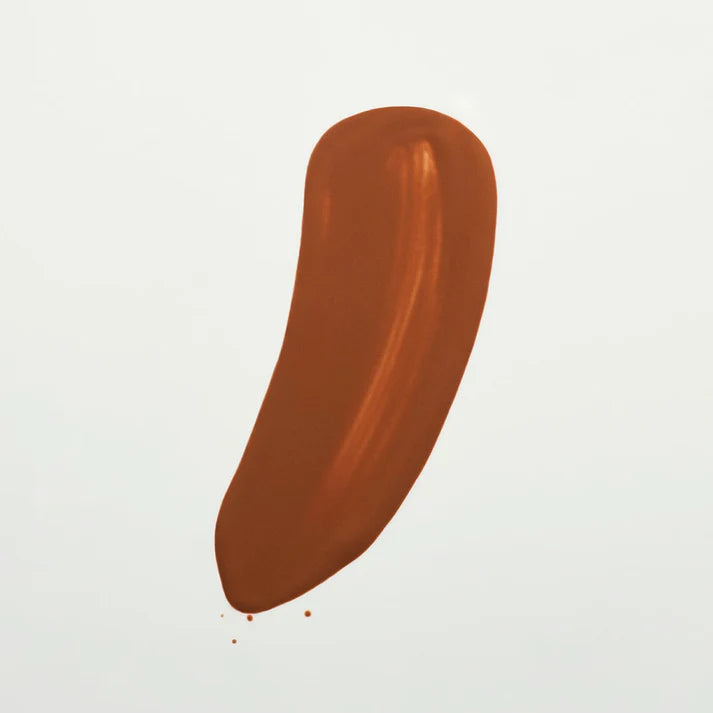 Brown foundation swatch on a white background