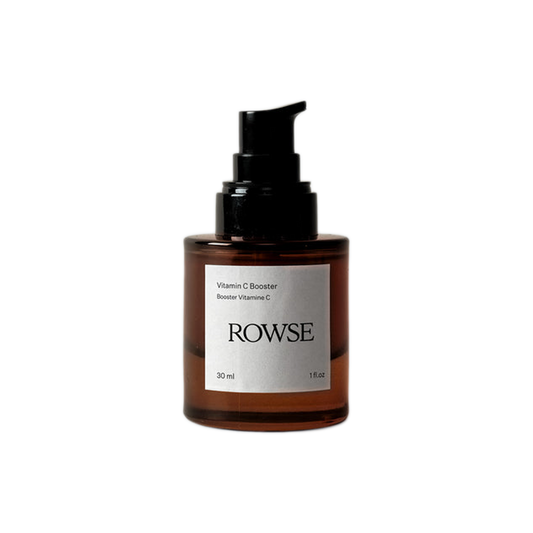A brown glass bottle with a black pump dispenser labeled 'ROWSE Vitamin C Booster', containing a skin care product.