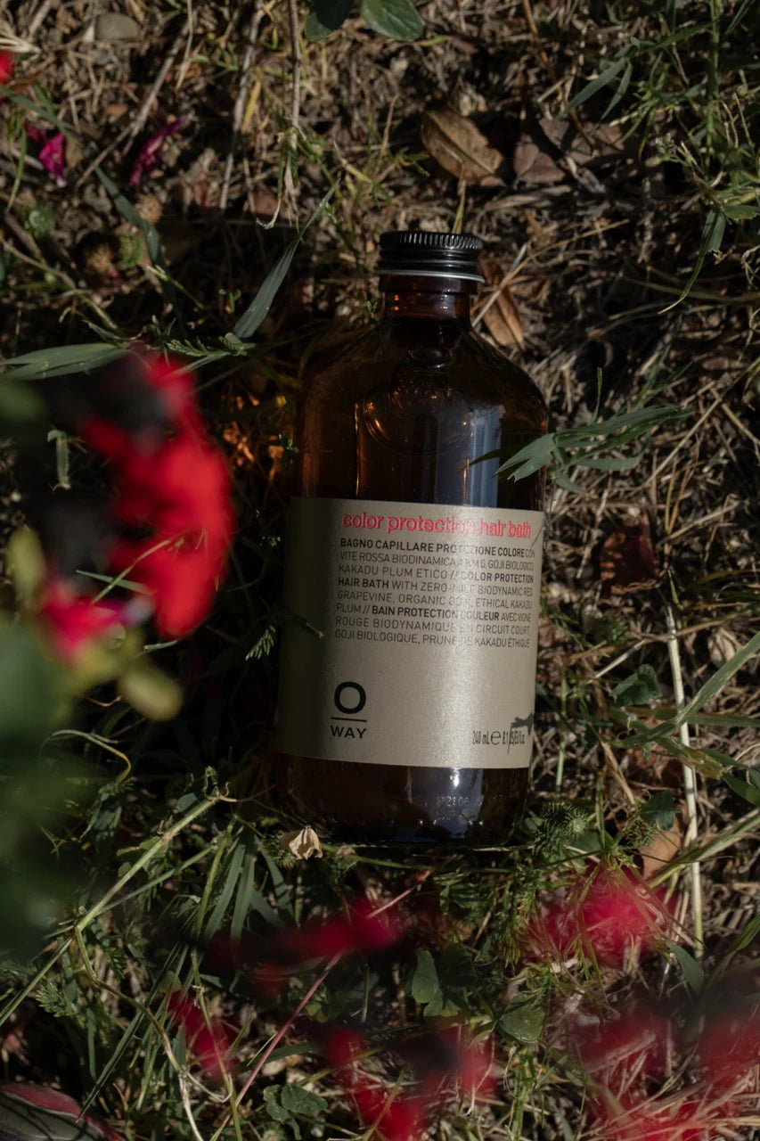 Brown glass bottle with a label on a grassy background