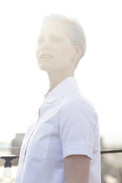 Full editorial portrait showcasing bright overall blonde hair and natural movement after organic root service