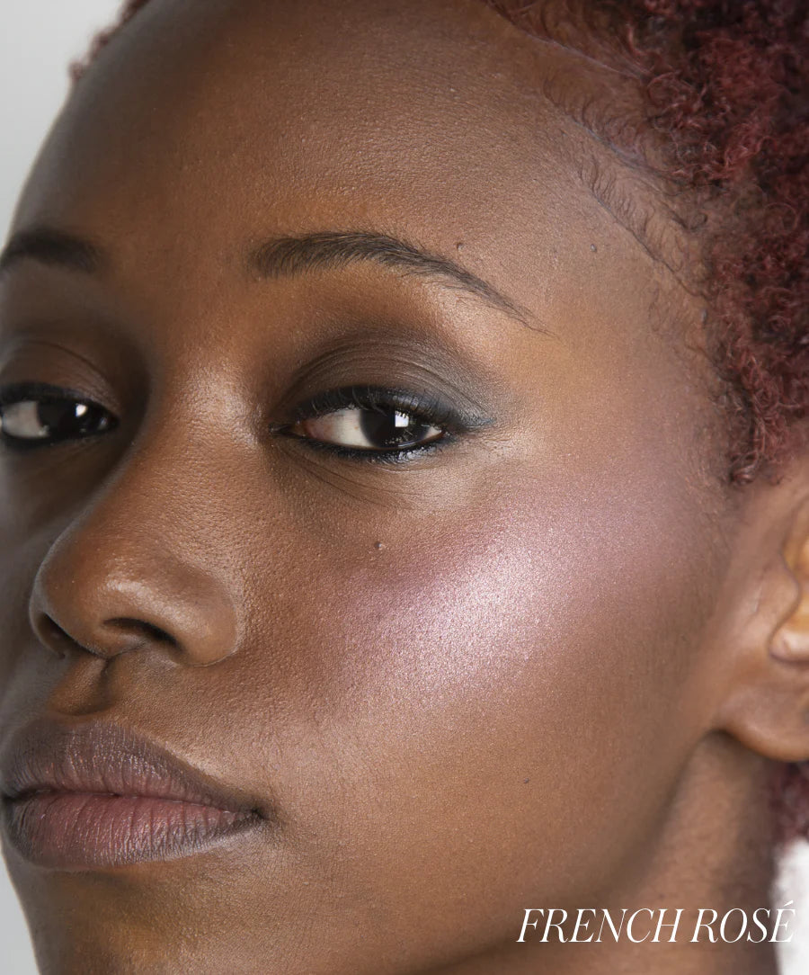 Close-up of a person's face with 'French Rose' branding.