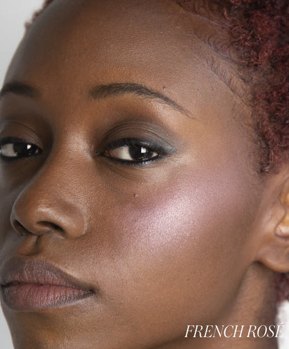 Close-up of a person's face with 'French Rose' branding.