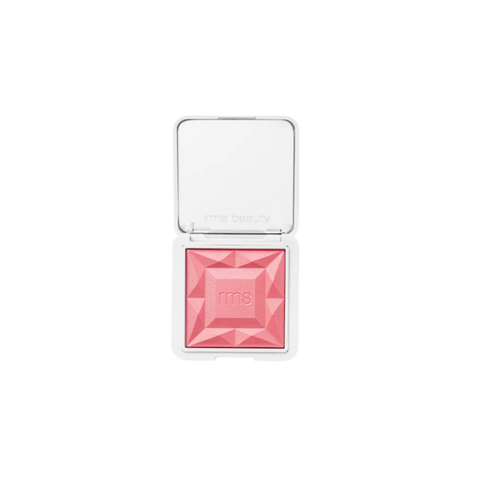 RMS Beauty diamond-shaped pressed blush in a white compact with a clear lid, shown open on a white background.
