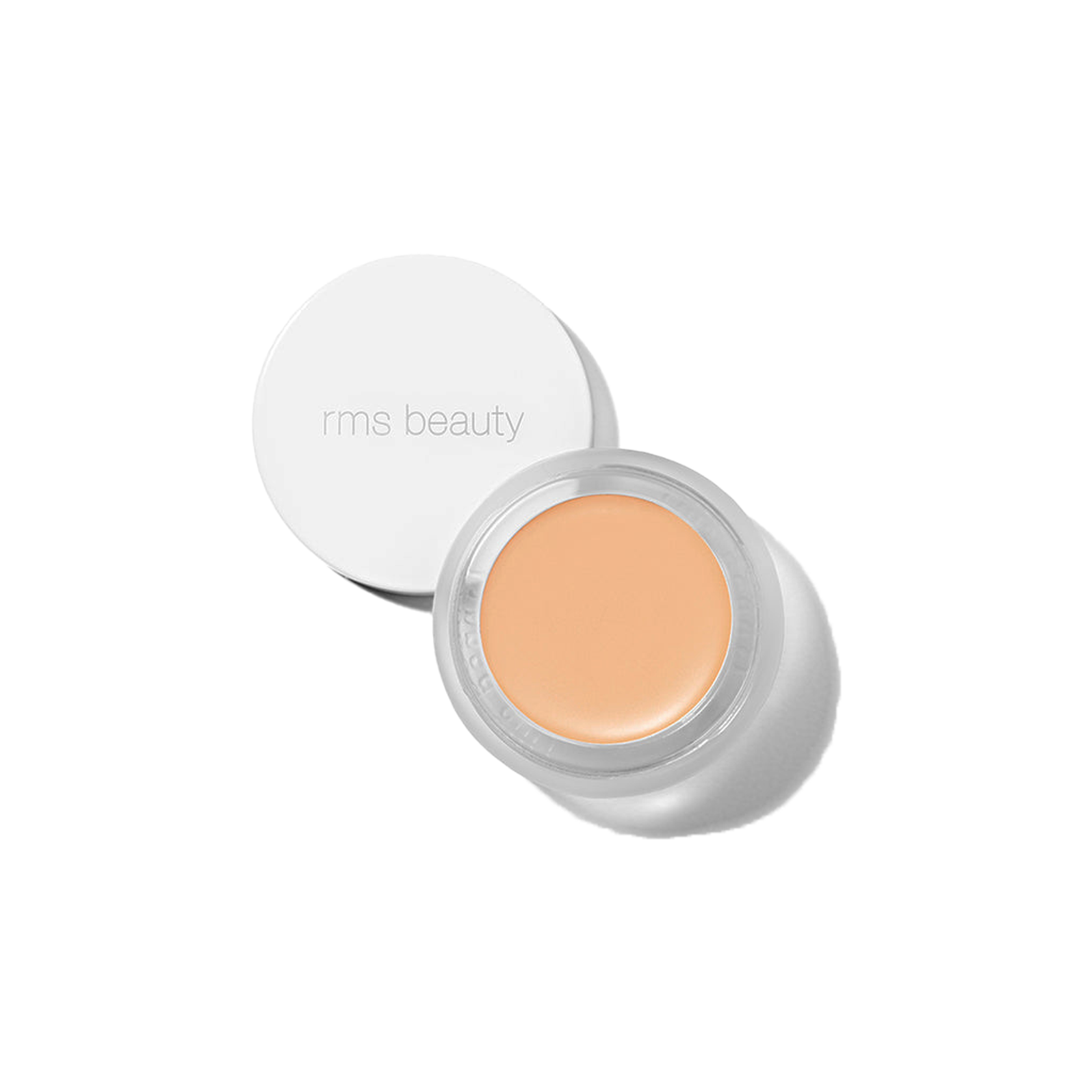 RMS Beauty UnCover-Up cream concealer shade 11.5 in open glass jar with white lid against a transparent background