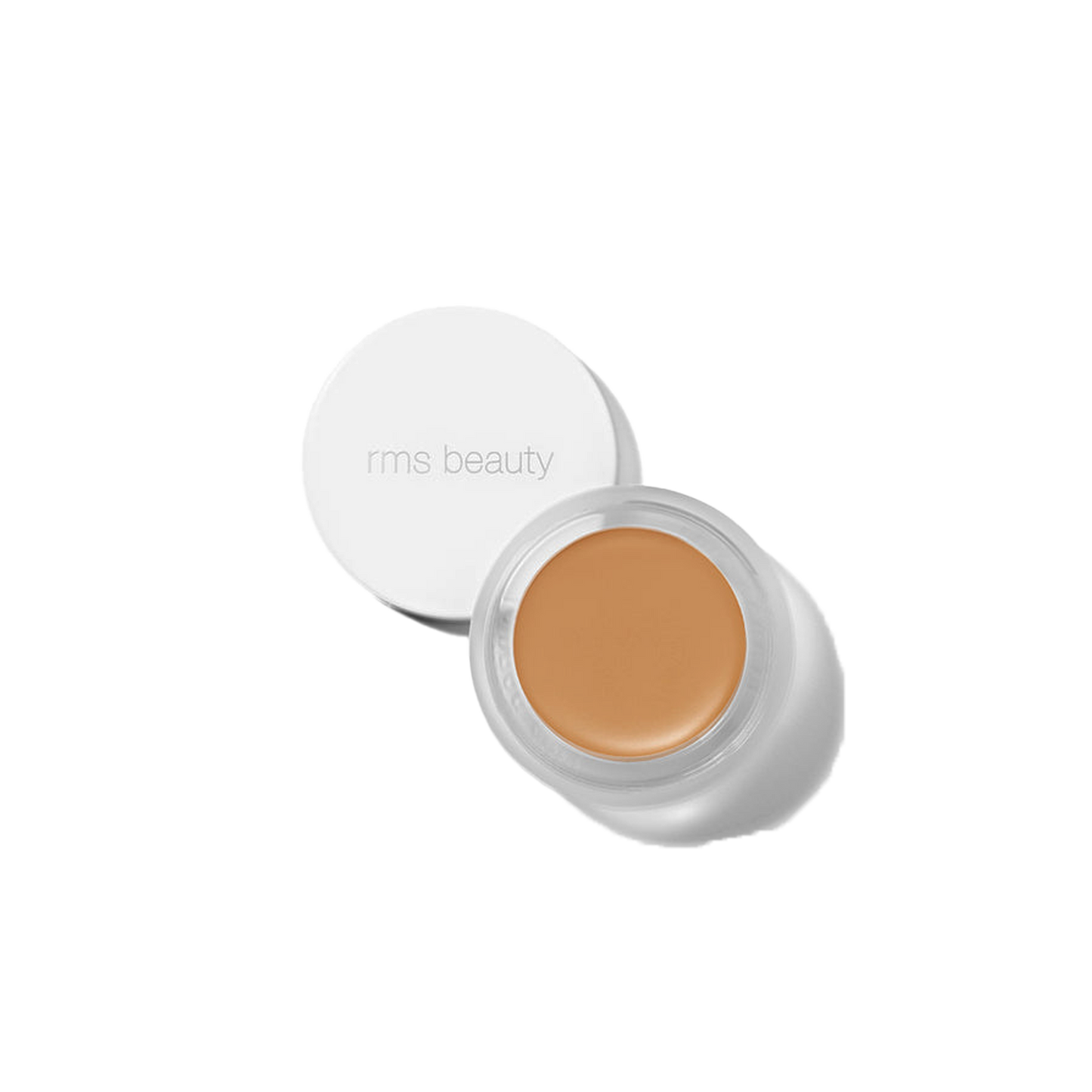 RMS Beauty UnCover-Up cream concealer in shade 55 tanned amber olive undertone in clear glass jar on transparent background